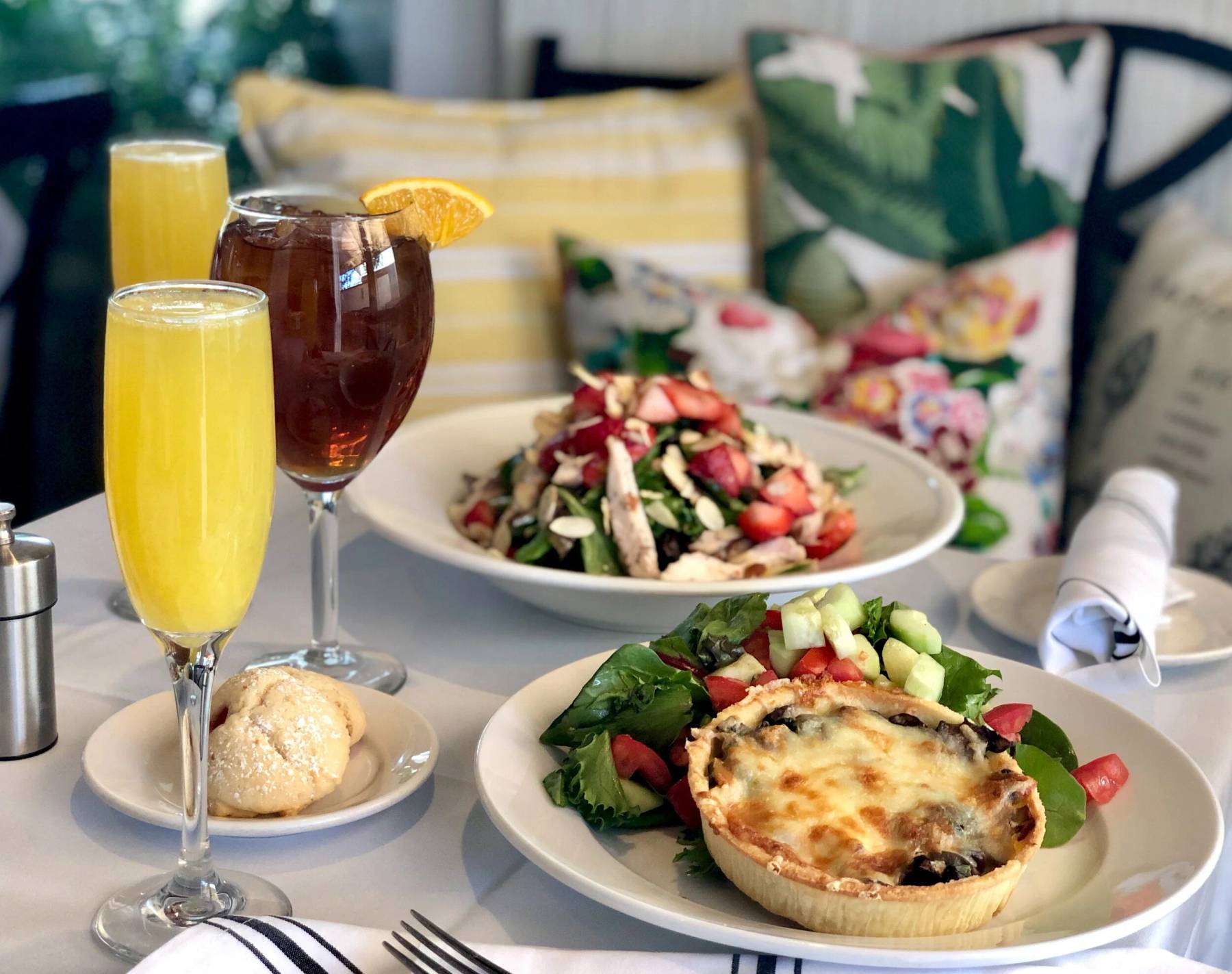 Quiche, salad and mimosas on a cafe table